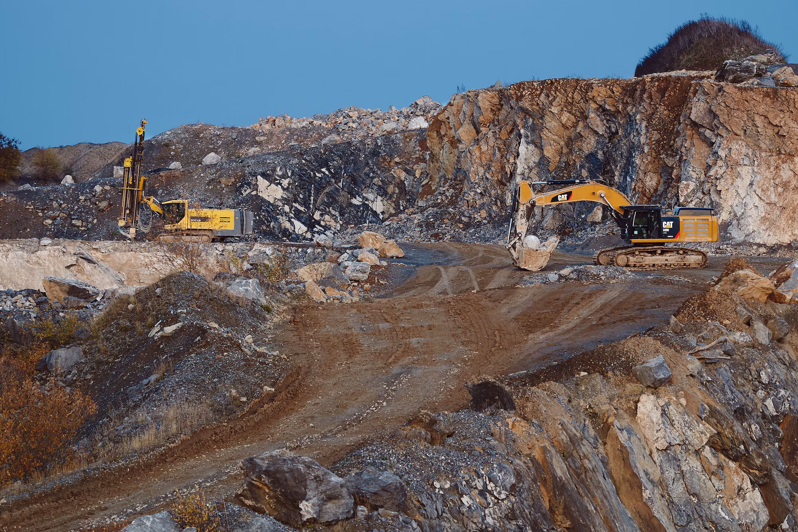 High-resolution industrial quarry and limestone mining excavation with hydraulic machinery